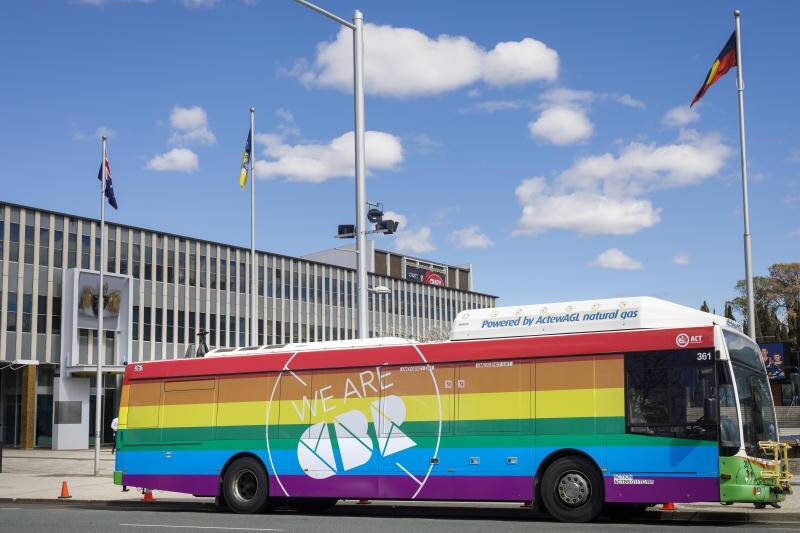 A bus painted in rainbow colours in support of marriage equality parks in front of the ACT Legislative Assembly. Photo: Sitthixay Ditthavong