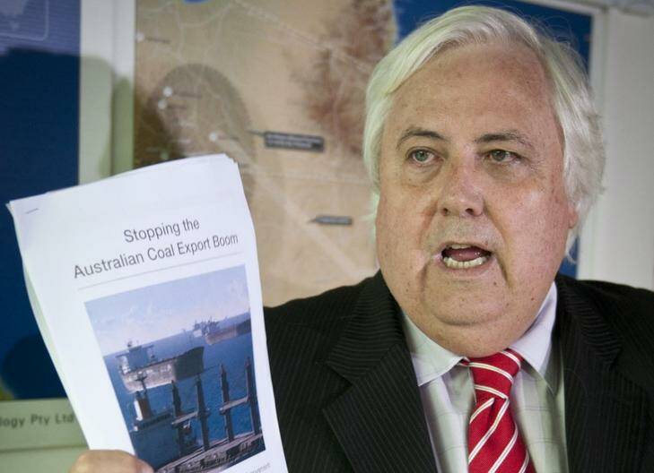 Mining magnate Clive Palmer talks up his conspiracy theories, brandishing a report by anti-coal groups, in Brisbane yesterday.