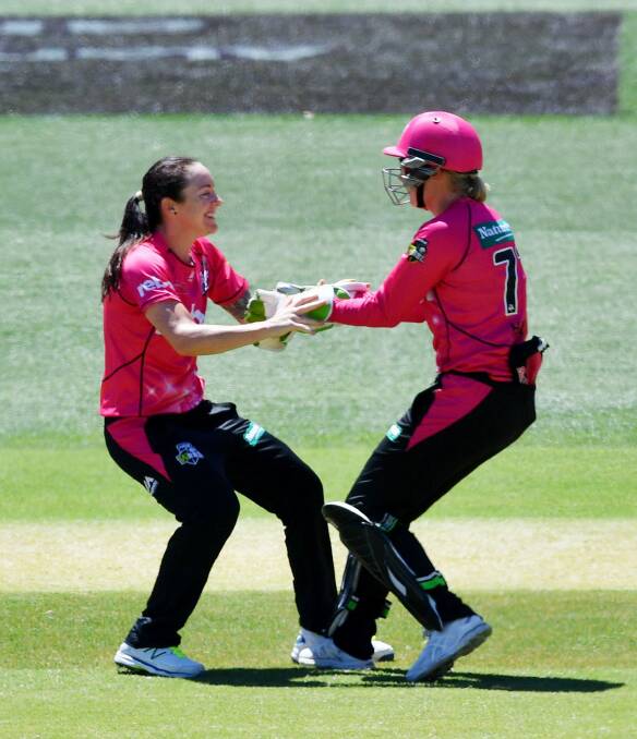Key wicket: Sarah Coyte and Alyssa Healy celebrate the dismissal of Elyse Villani. Photo: AAP