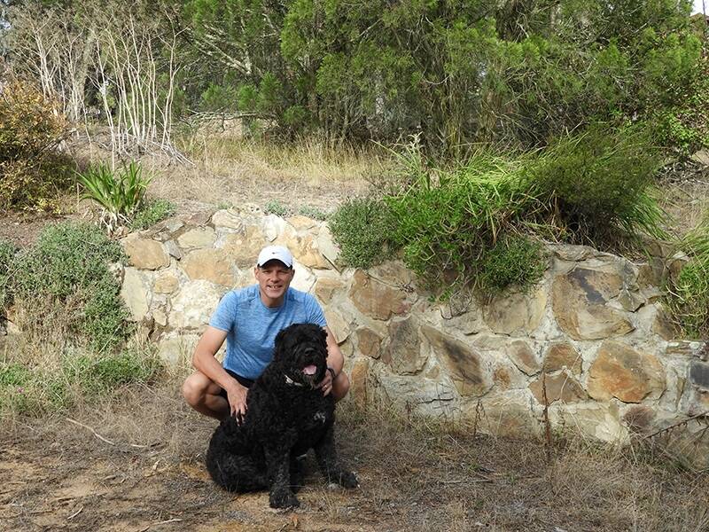 Brendan Greenwood, with his black dog Boston, is running from Sydney to Canberra to raise funds and awareness for mental health support. Photo: Supplied