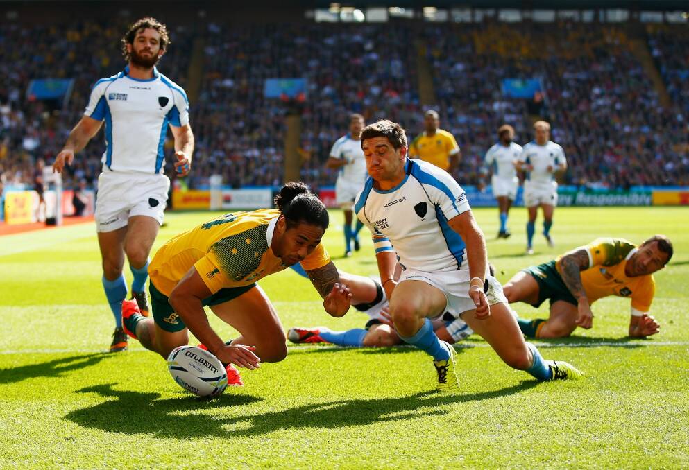 Joe Tomane scores a try during the 2015 Rugby World Cup Pool A match between Australia and Uruguay at Villa Park. Photo: Laurence Griffiths