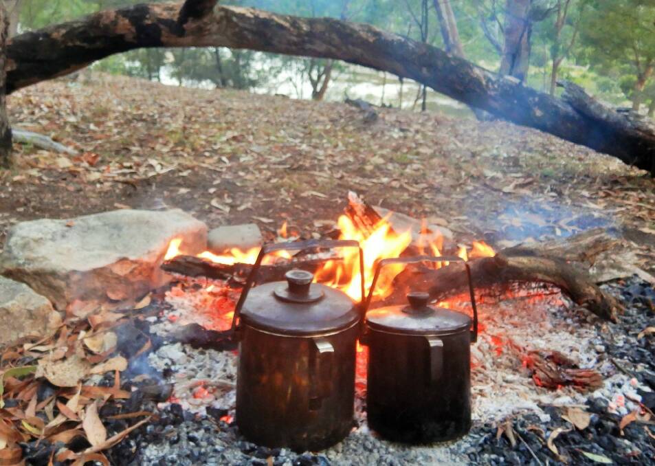 The billy boils as we set up camp and Swainy prepares dinner. P Photo: Tim the Yowie Man
