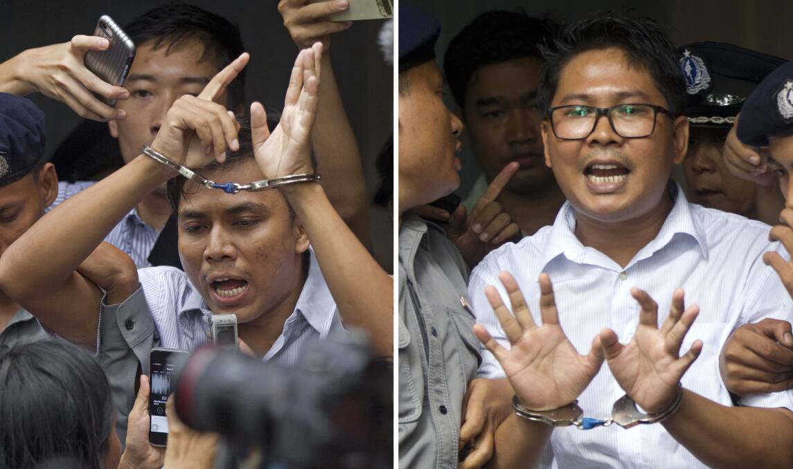 Reuters journalists Kyaw Soe Oo, left, and Wa Lone are escorted by police out of court on September 3. Photo: AP