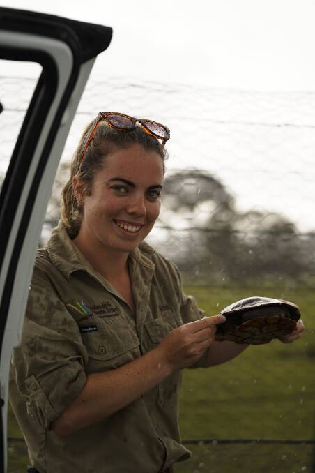 Woodlands and Wetlands Trust Indigenous project officer Kristi Lee with an eastern long neck turtle. Photo: Lawrence Atkin