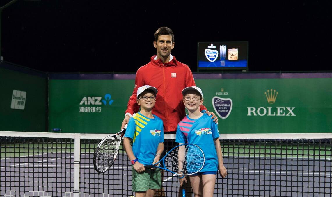 Novak Djokovic with Canberra's Caillie Warwick and Aston Monteleone after winning a Hot Shots competition. Photo: Supplied