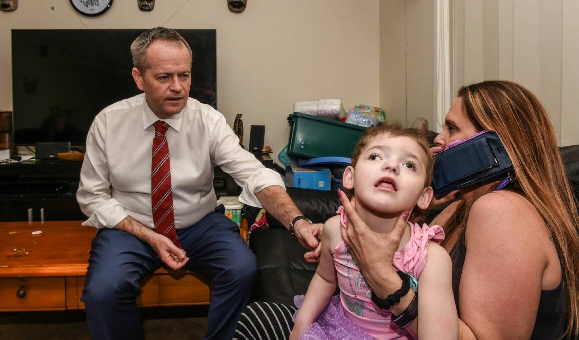 Federal Opposition leader Bill Shorten with Cherie Dell and her daughter Abbey, 3, who suffers from the very rare genetic disorder CDKL5. Photo: Brendan Esposito