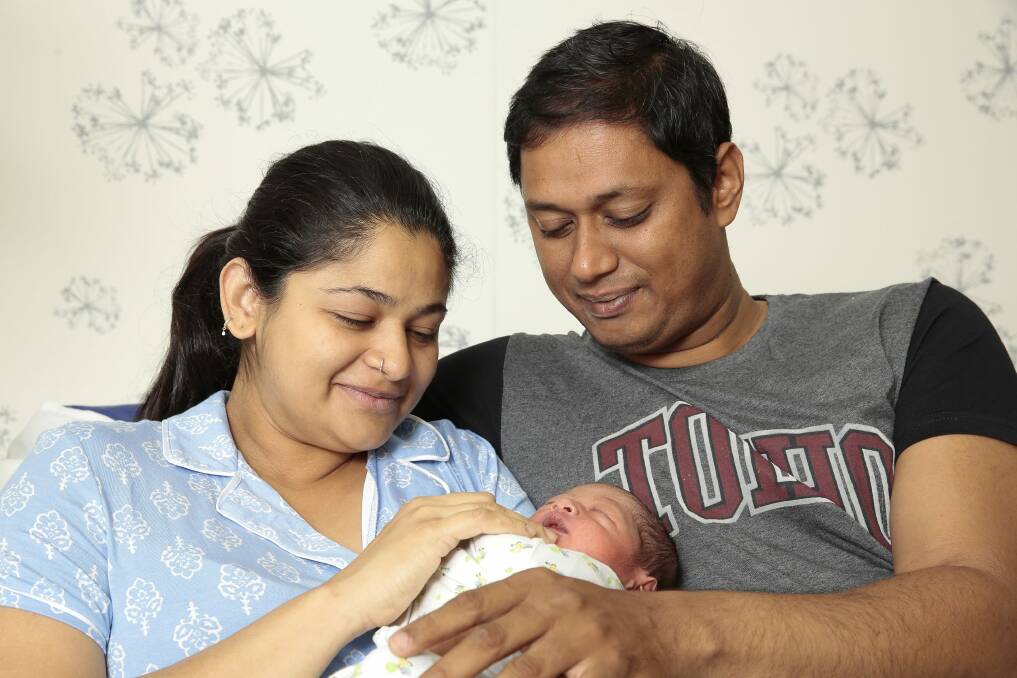 Mum Seethal Menon of Watson with partner Thomas George and their new baby boy Ronith born at 12:59am at the Centenary Women and Children's Hospital on New Years Day. Photo: Jeffrey Chan