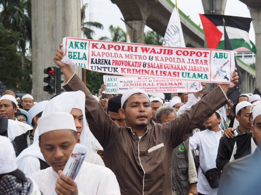 The Palestinian flag (seen here top right) is a common sight at mass protests in Jakarta. Photo: Dewi Nurcahyani