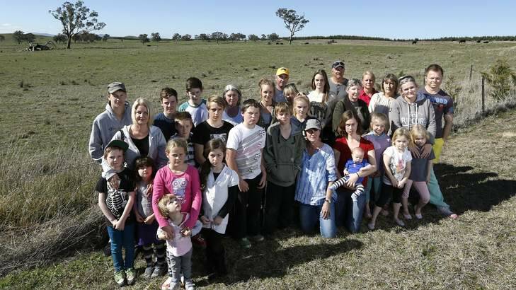 Residents gather in front of the proposed site for a solar farm across the road to Uriarra Village. Photo: Jeffrey Chan