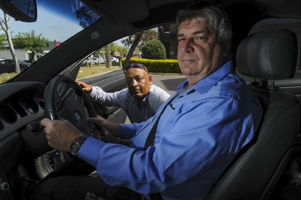 Prospective Uber drivers Teferi Gungul, left, and Gary Woodbridge will have their cars tested next week as Uber prepares to start operating in Canberra. Photo: Graham Tidy