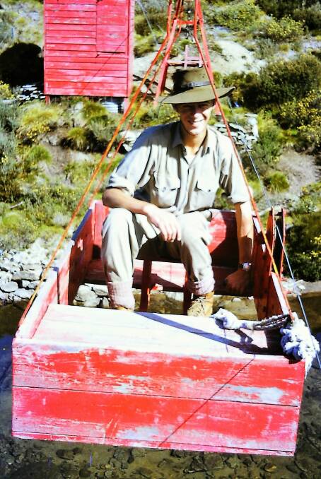Paul Hely crossing the Valentine Creek to the north-west of Guthega, in a flying fox in May 1965. Photo: Paul Hely
