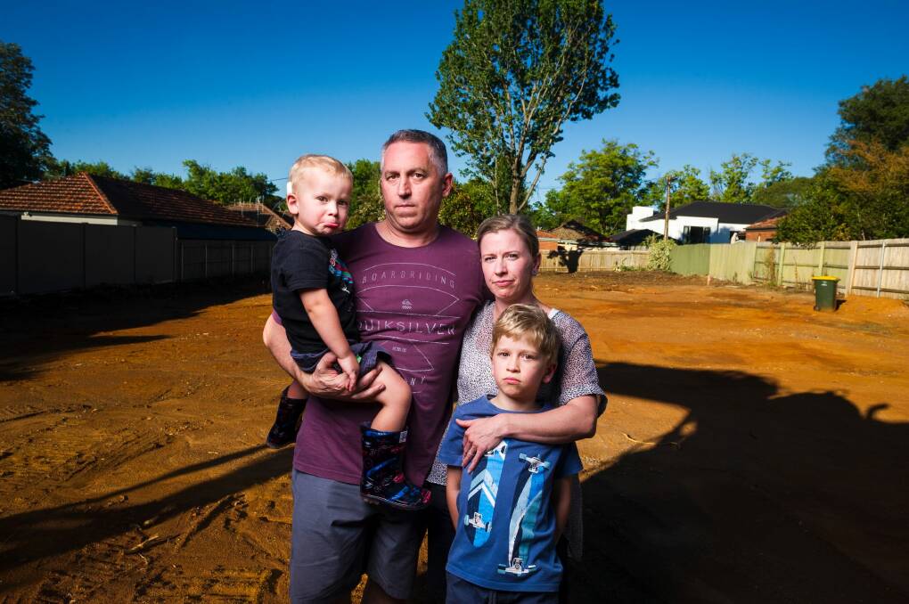 Anthony Steve and Clare Steve with their kids Oliver, 3, and Alexander, 7, paid $1.6 million for a Mr Fluffy block with friends, however asbestos has been found on the land. Photo: Dion Georgopoulos