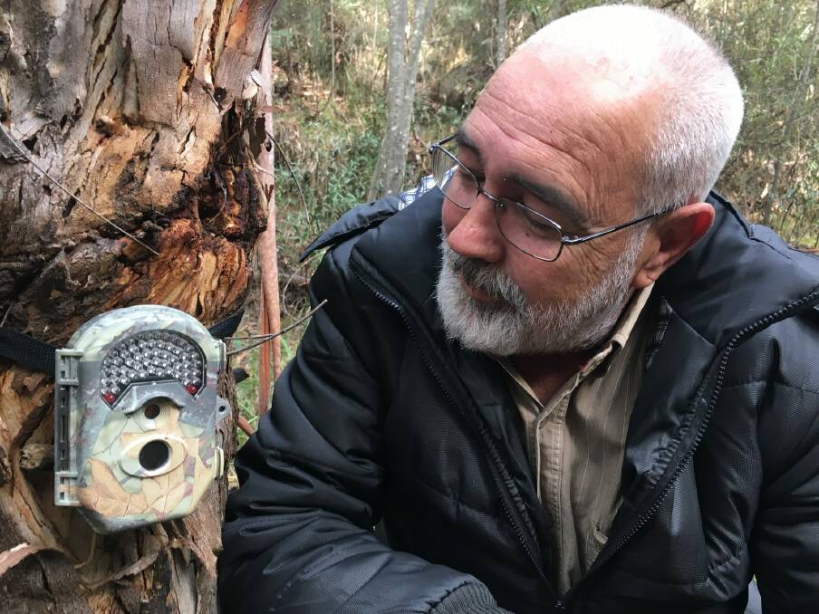 Dave Reid and his trail camera set in the bush. Photo: Tim the Yowie Man