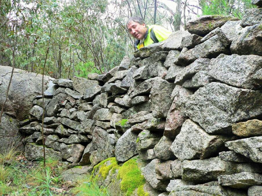 Phill Sledge, of Kaleen, at Namadgi National Park's mystery wall. Photo: Tim the Yowie Man