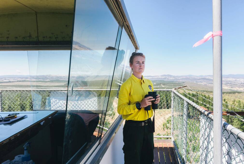 Seasonal firefighter Kirsty Babington at the Kowen Forest fire tower overlooking Canberra's surrounds. Photo: Rohan Thomson