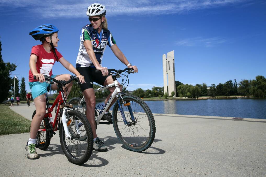 Max Millgate, 8, of Hughes, enjoys a ride around Lake Burley Griffin with his mother Sally Clark. Photo: Jeffrey Chan