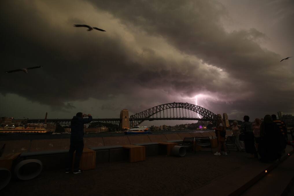 A lightning bolt strikes the Sydney Harbour Bridge. Photo: AAP