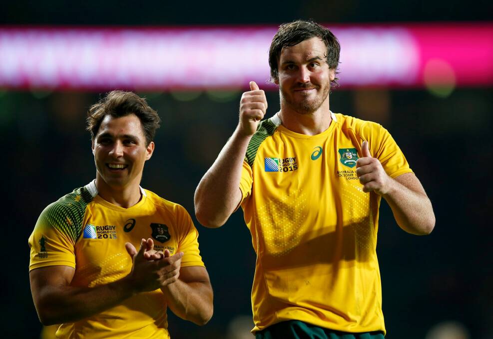 Delighted duo: Kane Douglas (right) and Nick Phipps celebrate after the 2015 Rugby World Cup Pool A match between Australia and Wales at Twickenham Stadium. Photo: Mike Hewitt