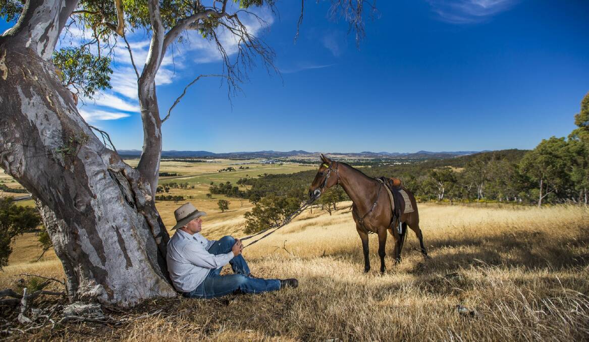 Paul Keir and his Australian stock horse Springfield Scrumlo overlooking the Majura Valley. Photo: Matt Bedford