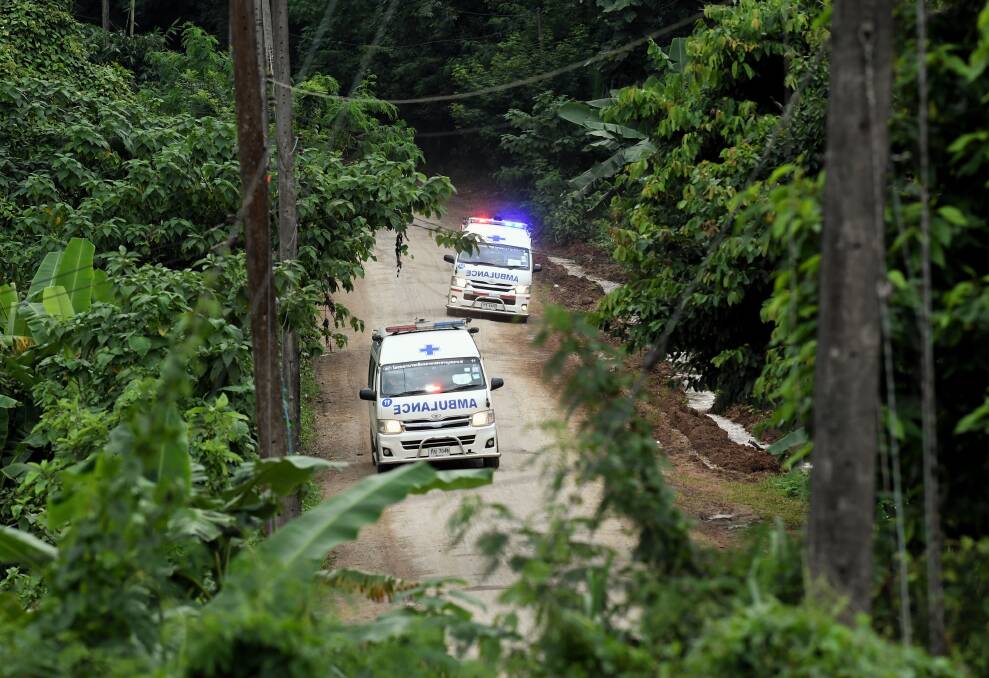 Ambulances carrying the 10th and 11th rescued drive away from Luang cave. Photo: Kate Geraghty