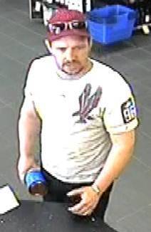 A still from CCTV footage showing a man believed to have used a stolen credit card. Photo: Supplied by ACT Policing