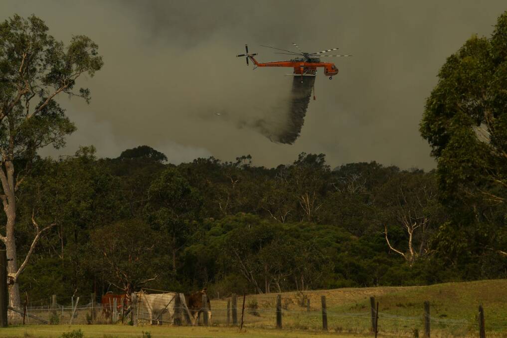 A waterbombing aircraft tackles a blaze in NSW during 2017. Photo: Jonathan Carroll