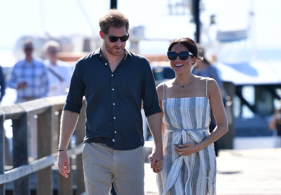 Prince Harry and his wife Meghan on Kingfisher Bay Jetty on Fraser Island on Monday. Photo: AAP Image/ Darren England