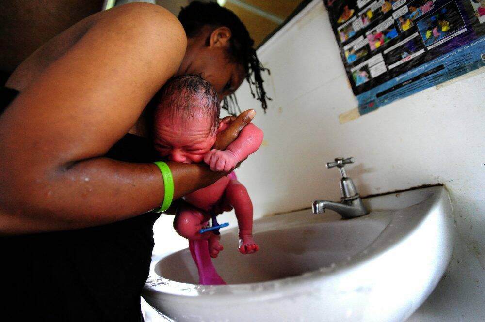 A newborn is bathed in the maternity ward at Port Moresby General Hospital. Photo: Karleen Minney