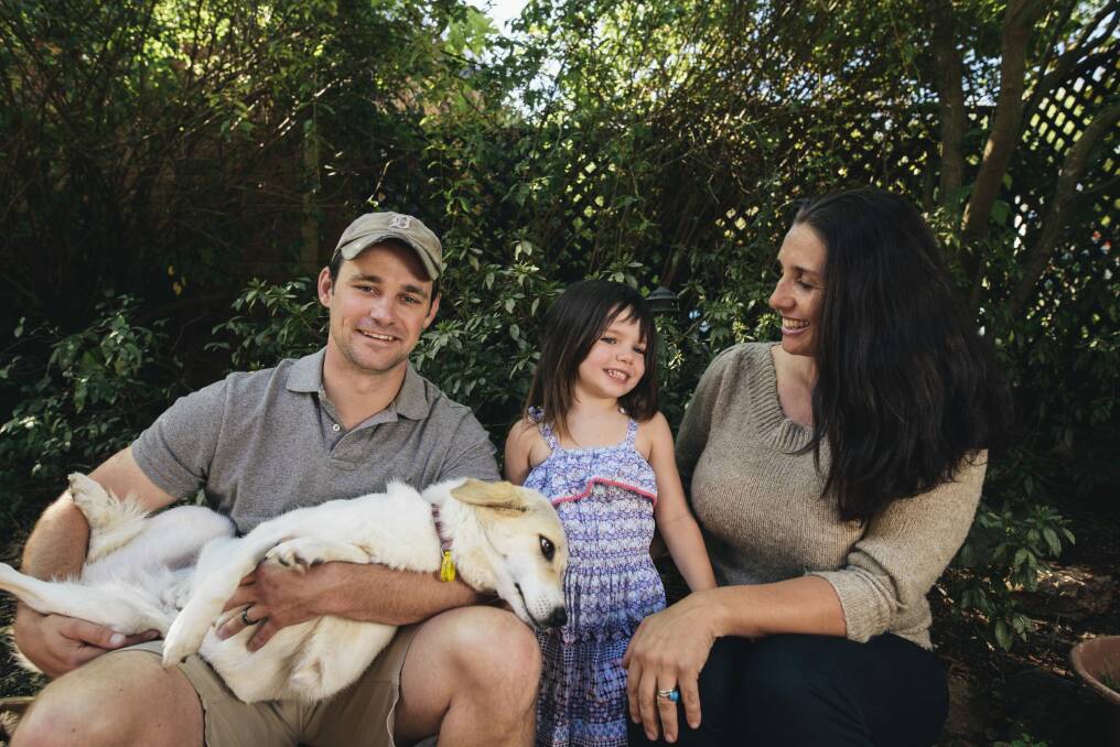 Former United States Marine
Eric Yarger with his wife Olympia and their daughter Charlotte, 4, at home in Isaacs with Snickle Fritz, the dog he rescued from a rubbish dump in Afghanistan. Photo: Rohan Thomson