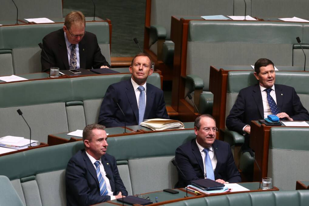 Former prime minister Tony Abbott and former defence minister Kevin Andrews take their seats on the backbench for question time. Photo: Alex Ellinghausen