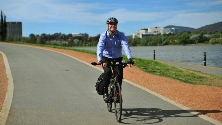 Catholic Health Australia policy director Patrick Tobin on his bike. Photo: Melissa Adams