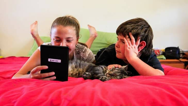 Jade Lewis, age 12, (pictured with 8 year-old brother Darcy) of Richardson received a kindle after improving her reading on the Indigenous Reading Project, a homegrown idea which has helped 100 indigenous children learn to read across Australia. Photo: Katherine Griffiths