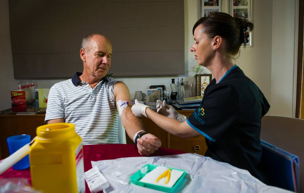 Registered Nurse, Lorraine Dwyer, caring for Hospital in the Home patient John Hall at his Kambah home. Photo: Elesa Kurtz
