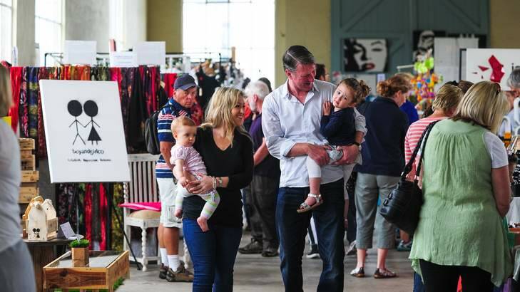 HOME HOLIDAY: VisitCanberra director Ian Hill enjoying a day at the Old Bus Depot Markets with his wife, Libby, and their daughters Lily, 3, and Stella, 10 months. Photo: Katherine Griffiths