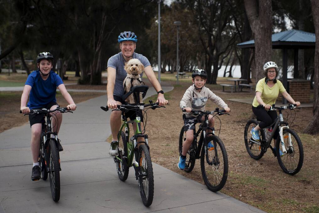 Darren, along with his sons Toby (left), Cameron, wife Sarah and dog Archie are participating in the Spring Financial Group Spring Cycle. Photo: Christopher Pearce