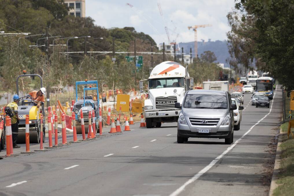 Workers reseal the turning lane from Northbourne Avenue onto Morphett Street.  Photo: Sitthixay Ditthavong