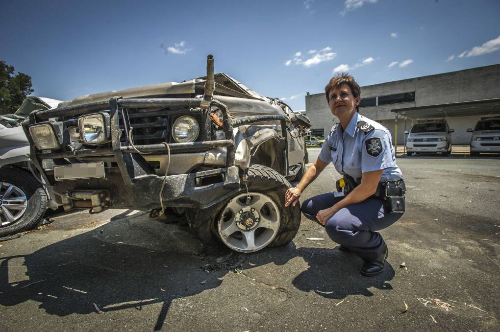 ACT Policing Station Sergeant Susan Ball with a Landcruiser ute involved in a serious single vehicle accident in Canberra suburb of Kenny on Tuesday night. Photo: Karleen Minney