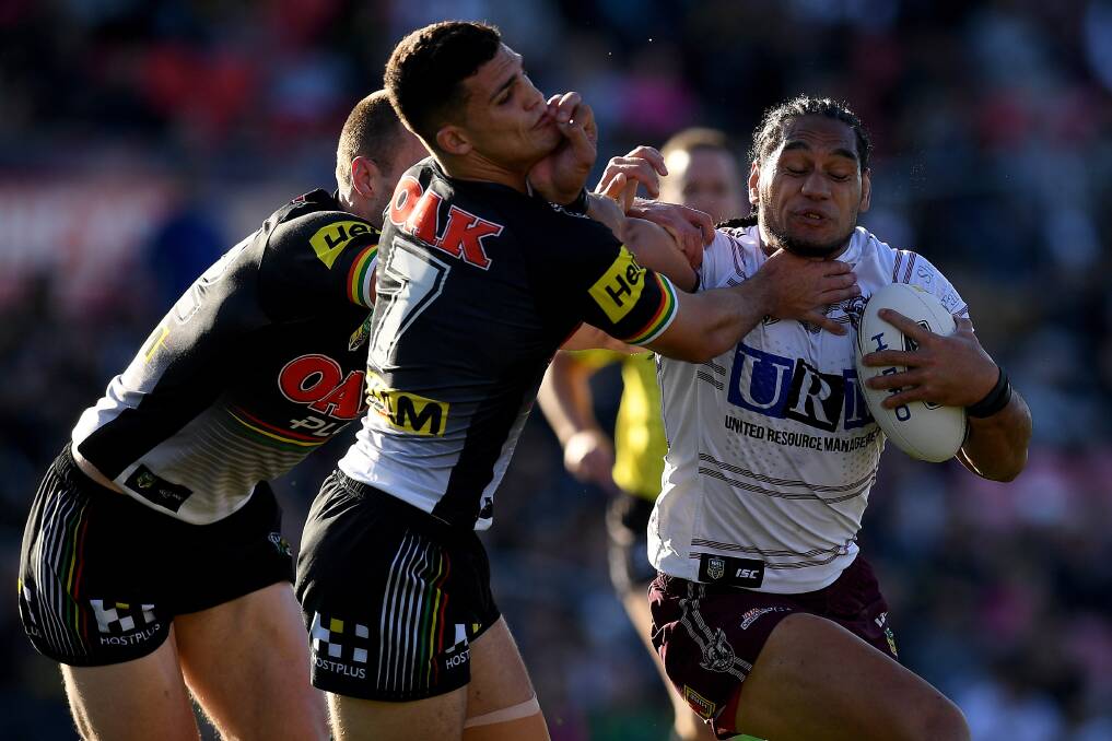 Don't argue: Martin Taupau of the Sea Eagles fends off Nathan Cleary at Panthers Stadium. Photo: AAP