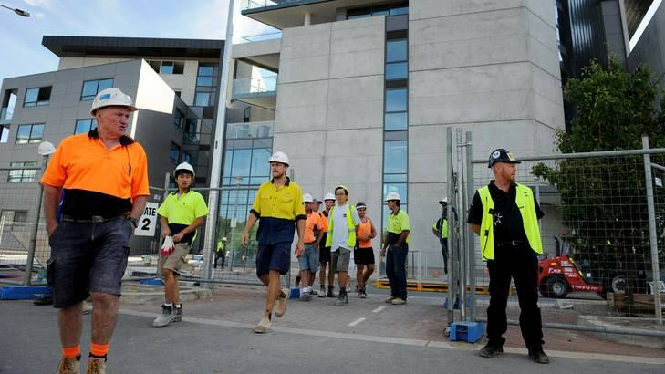 CFMEU Secretary Dean Hall (right) stands at the Aurora apartments this morning as workers are ordered off the site, so a safety inspection can take place. Photo: Colleen Petch