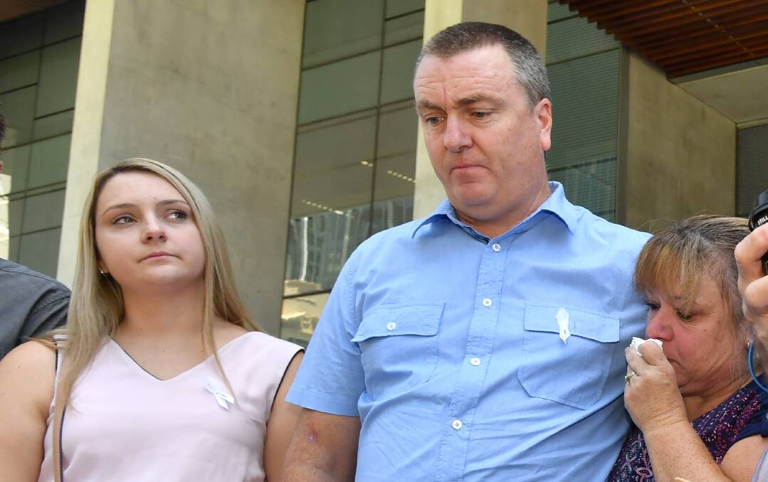 Patricia Riggs' brother Mark Knowles, of Canberra, with his wife Tracy and their daughter Tracy outside the court in Brisbane on Wednesday. Photo: AAP
