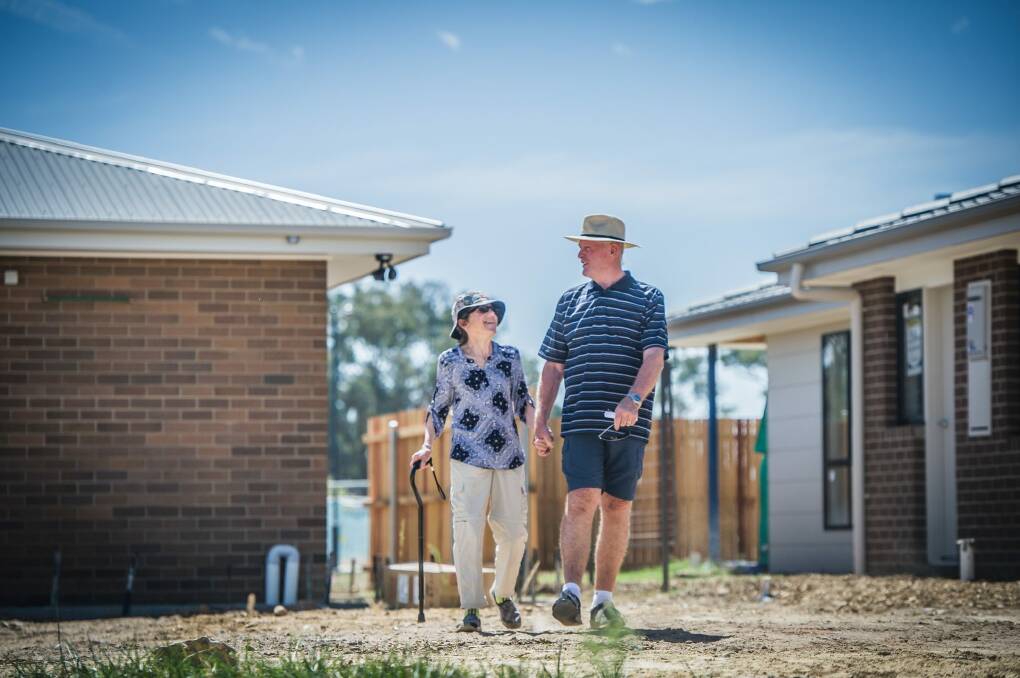 Lee and Jacqui Forster walk across their block of land in Throsby.  Photo: karleen minney