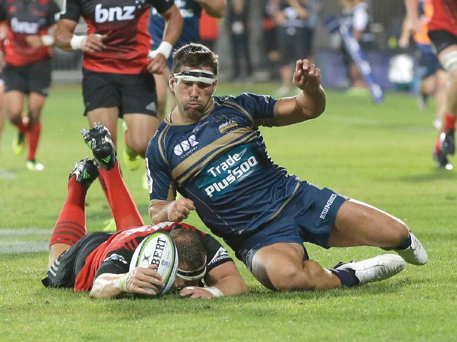 The Brumbies' Chris Alcock, right, and Crusaders' Wyatt Crockett compete for the ball. Photo: AP