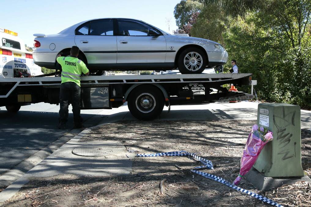A car is removed from the house by ACT Policing on Thursday. Photo: Jeffrey Chan