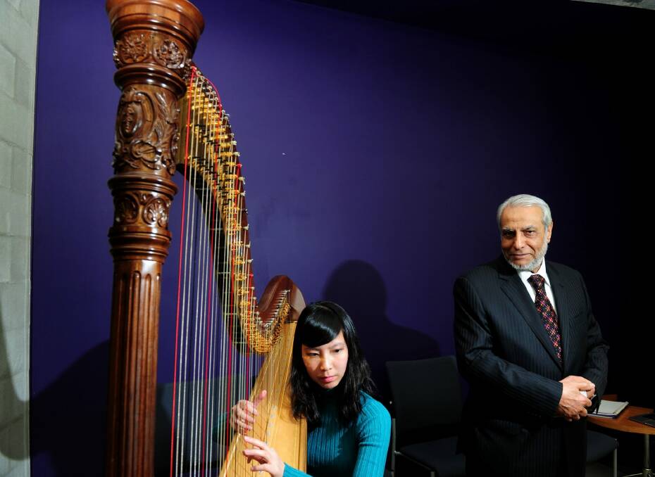 The Grand Mufti of Australia Professor  Ibrahim Abu Mohammed at the Australian Centre for Christianity and Culture to speak at the Bluestar 6th annual Social Harmony Iftar Dinner whilst Laura Tanata of Casey plays the harp.    Photo: Melissa Adams