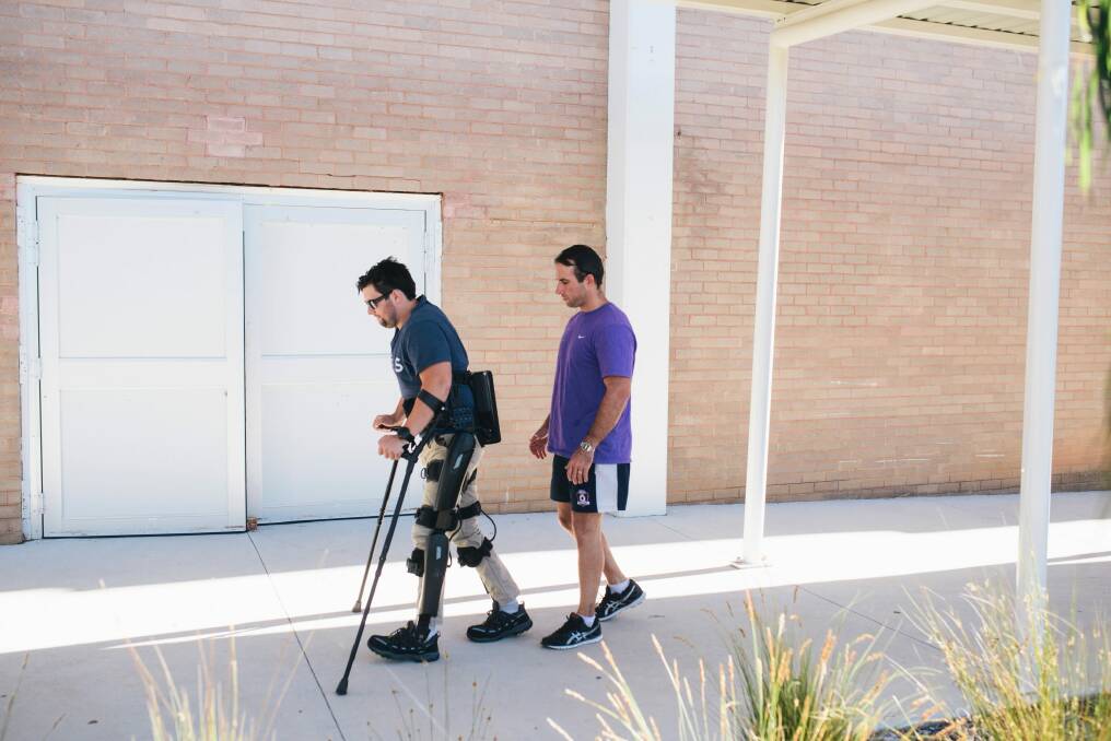 Paul Jenkins spent months learning to walk with bionic legs with exercise physiologist Jim Barrett. Photo: Rohan Thomson