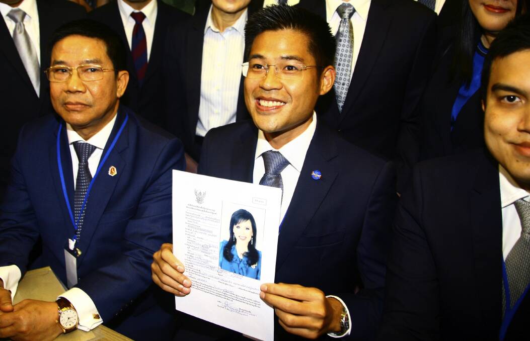 Thai Raksa Chart party leader Preecha Pholphongpanich holds a picture of Princess Ubolratana, announcing she will be their prime ministerial candidate. Photo: AP