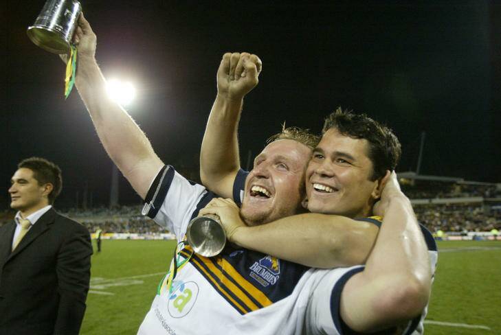 Bill Young, left, celebrates the Brumbies' 2004 Super Rugby title with Jeremy Paul. Photo: Simon Alekna