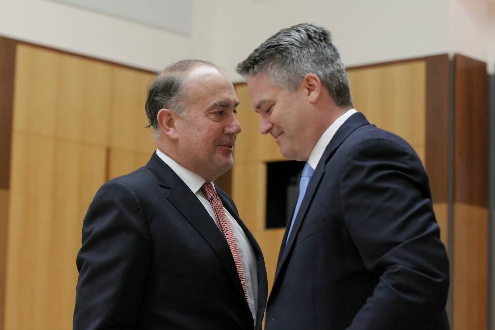 Treasury chief John Fraser (left) and Finance Minister Mathias Cormann (right) expressed a different view on the report's ownership than did Treasurer Joe Hockey. Photo: Alex Ellinghausen 