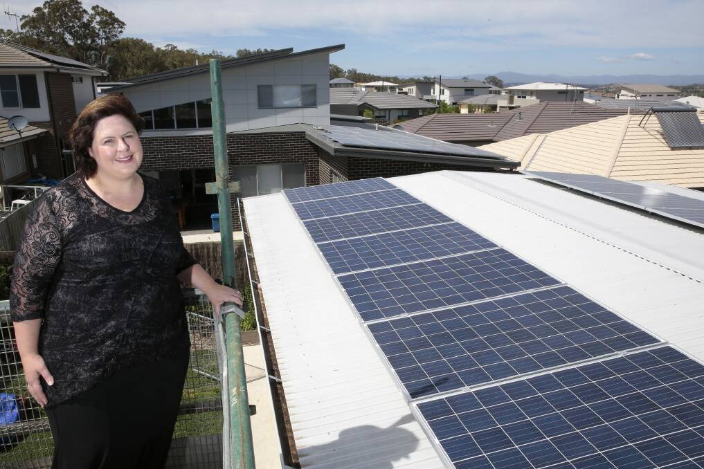 Rachael Turner of Forde with her 5.2kW solar power system that has a battery storage system. Photo: Jeffrey Chan