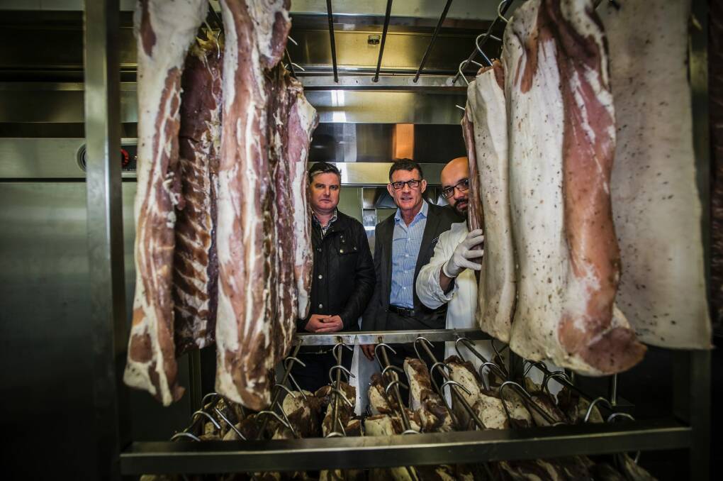 The award winning smoke-house Pialligo Estate has moved to a new location in Fairbairn after a fire gutted the building they were in. Checking out the new digs are general manager Charlie Costelloe, director Rowan Brennan and Smokehouse manager Alex Petryk, right. Photo: Karleen Minney